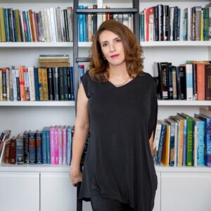 Author standing in front of book shelves